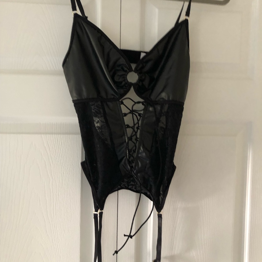 One piece lingerie with faux leather and lace. Attached garters